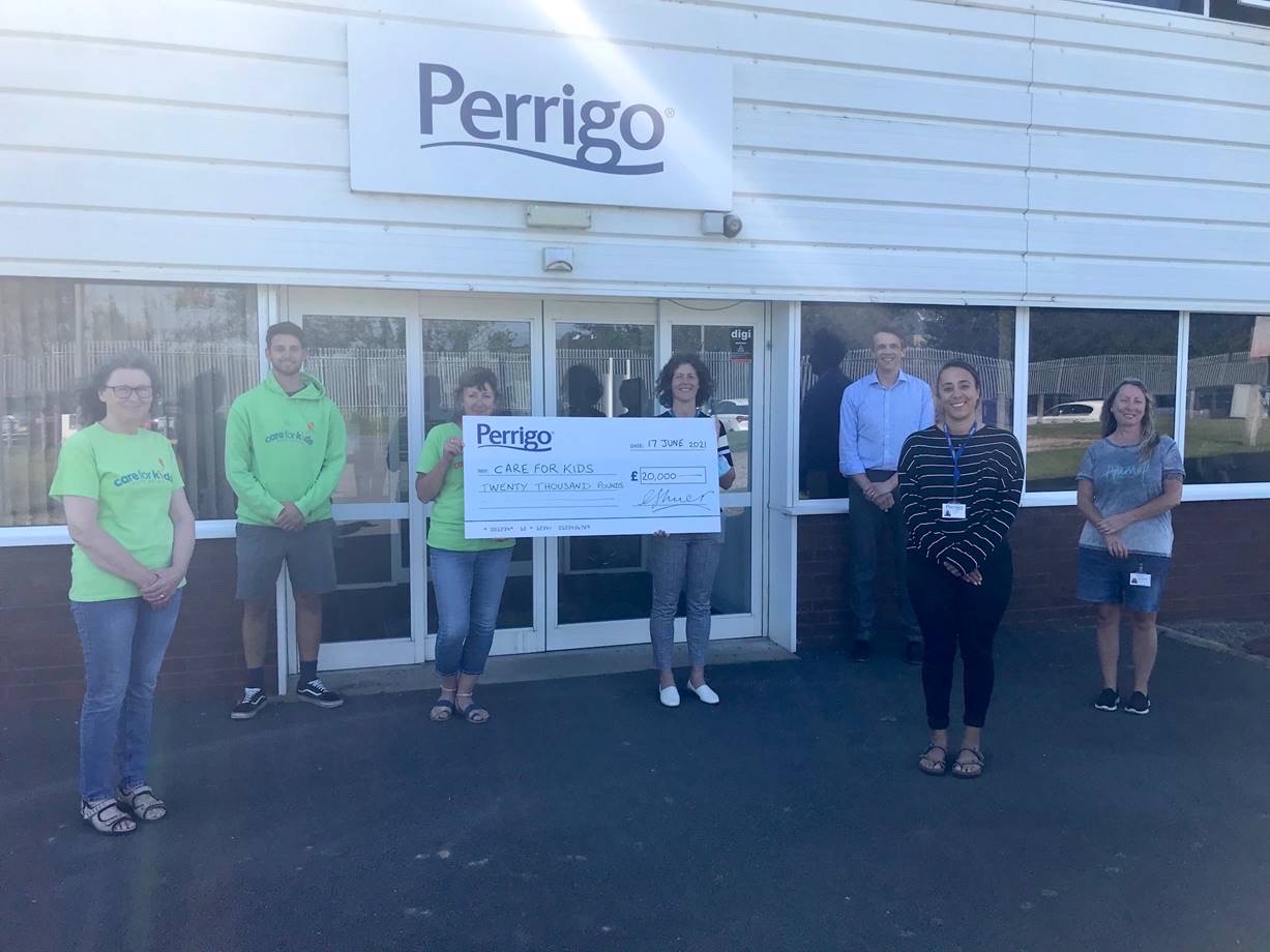 Care for Kids trustees and staff from Perrigo outside the Perrigo site with a giant cheque for £20,000